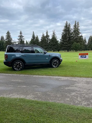 A Ford Bronco Sport on the course at a local golf tournament