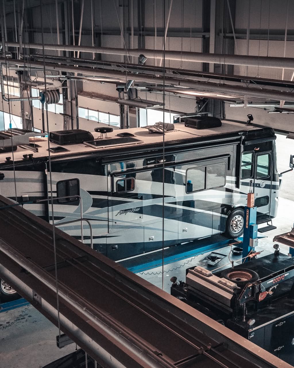 A large motorhome up on a hoist in the Windsor Ford service shop