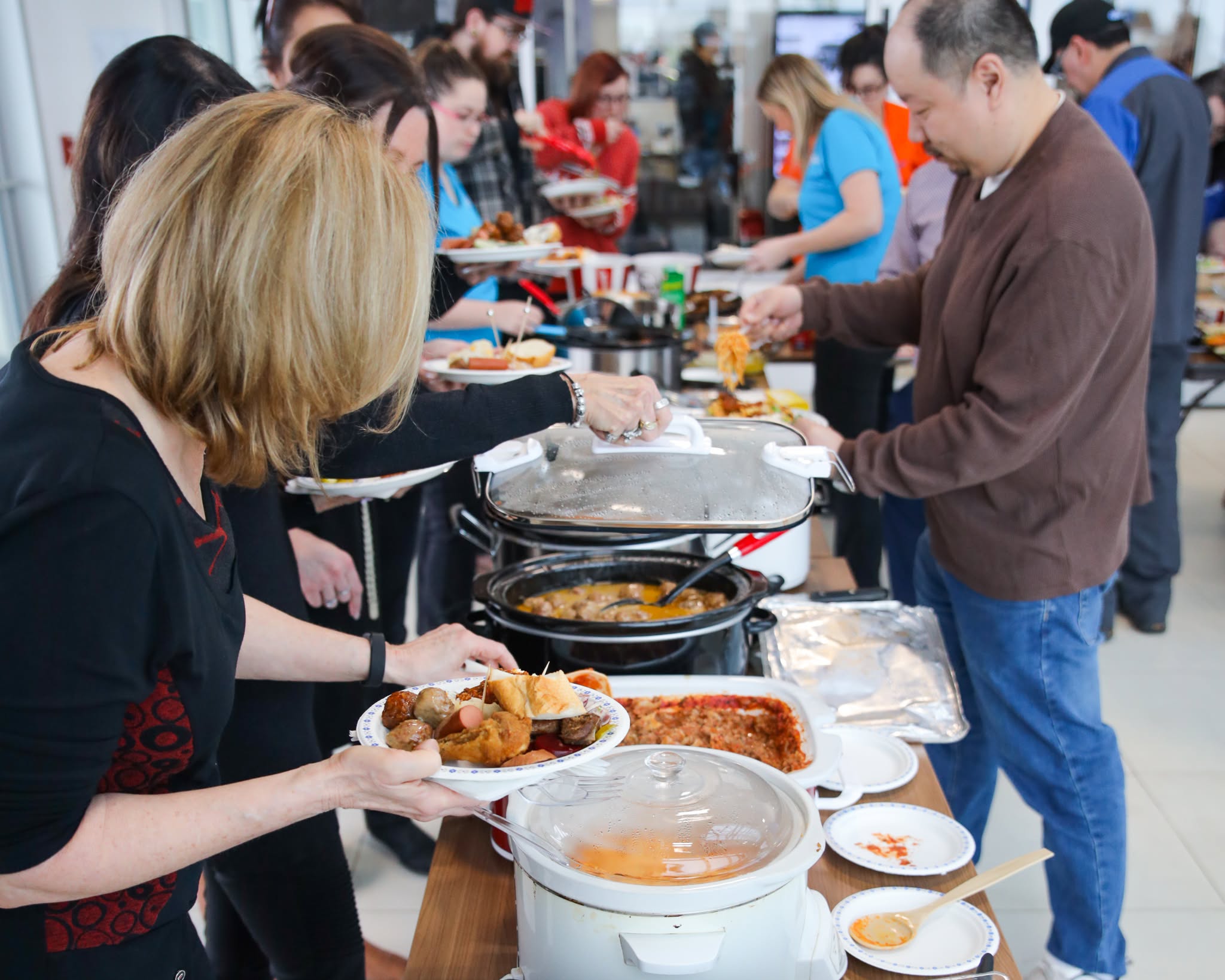 The Windsor Ford team gathered around the buffet at a staff potluck
