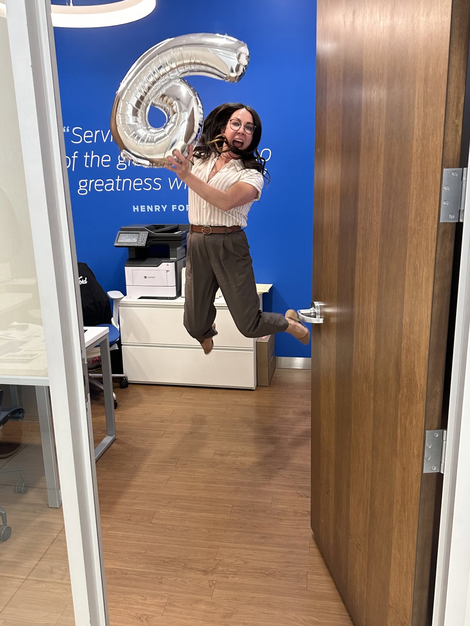 A staff member celebrating an anniversary with a balloon at Windsor Ford
