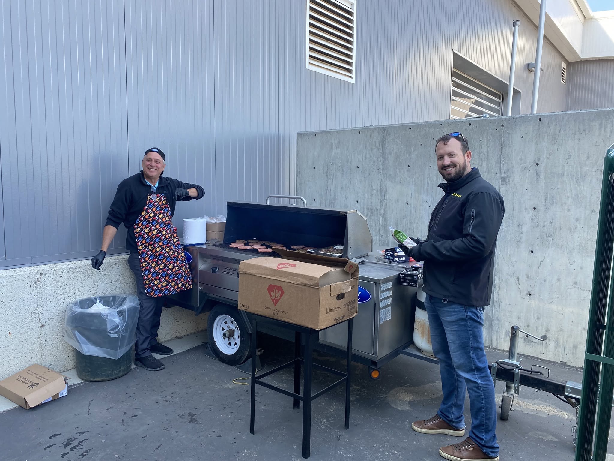 Windsor Ford team members grilling burgers at a staff BBQ