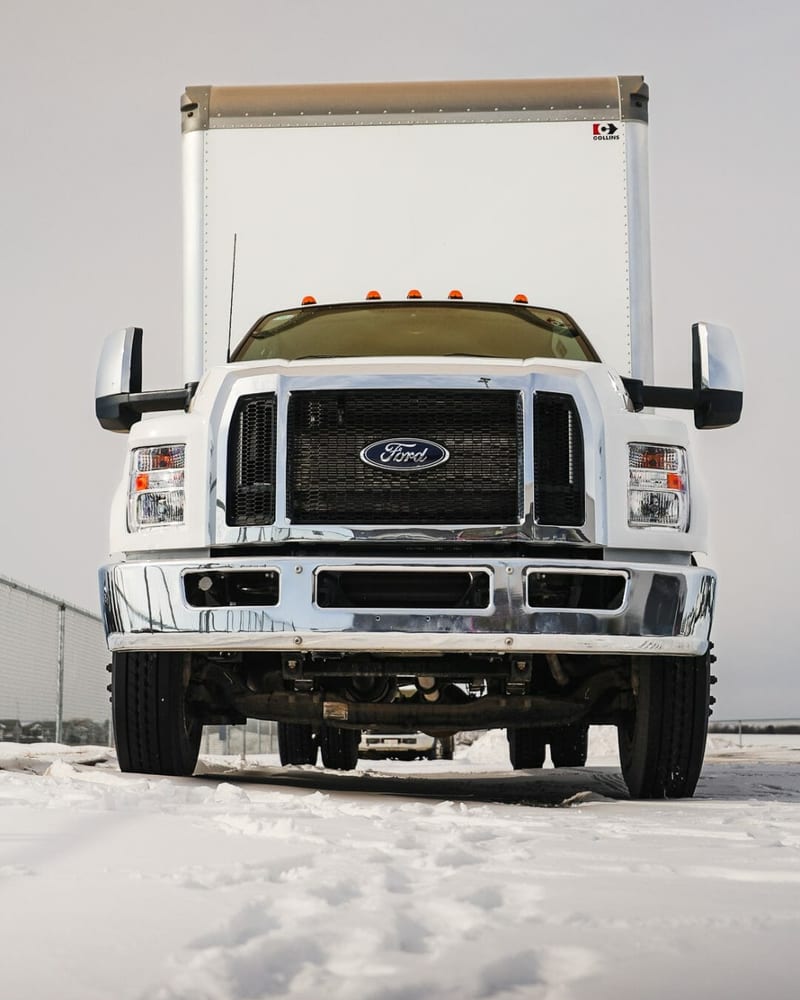 Ford F-750 with a Collins dry-freight box body on a snowy Grande Prairie lot
