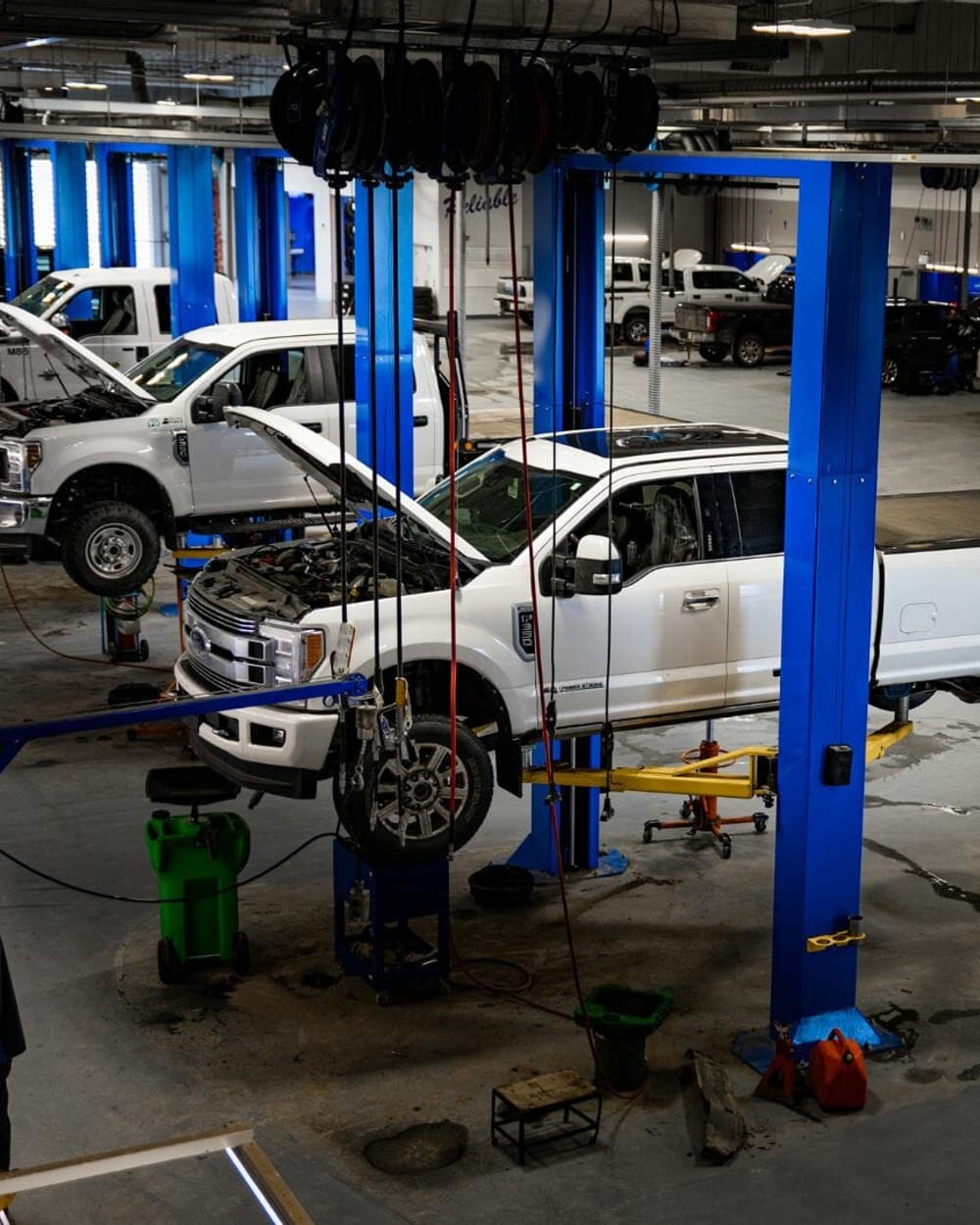 Ford Super Duty work trucks up on the hoists in the Windsor Ford commercial bays
