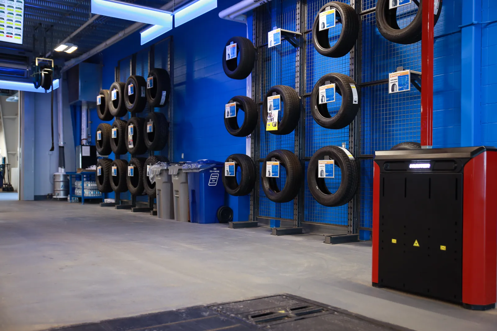The tire display wall at the Windsor Ford tire shop in Grande Prairie, tires mounted on blue racks